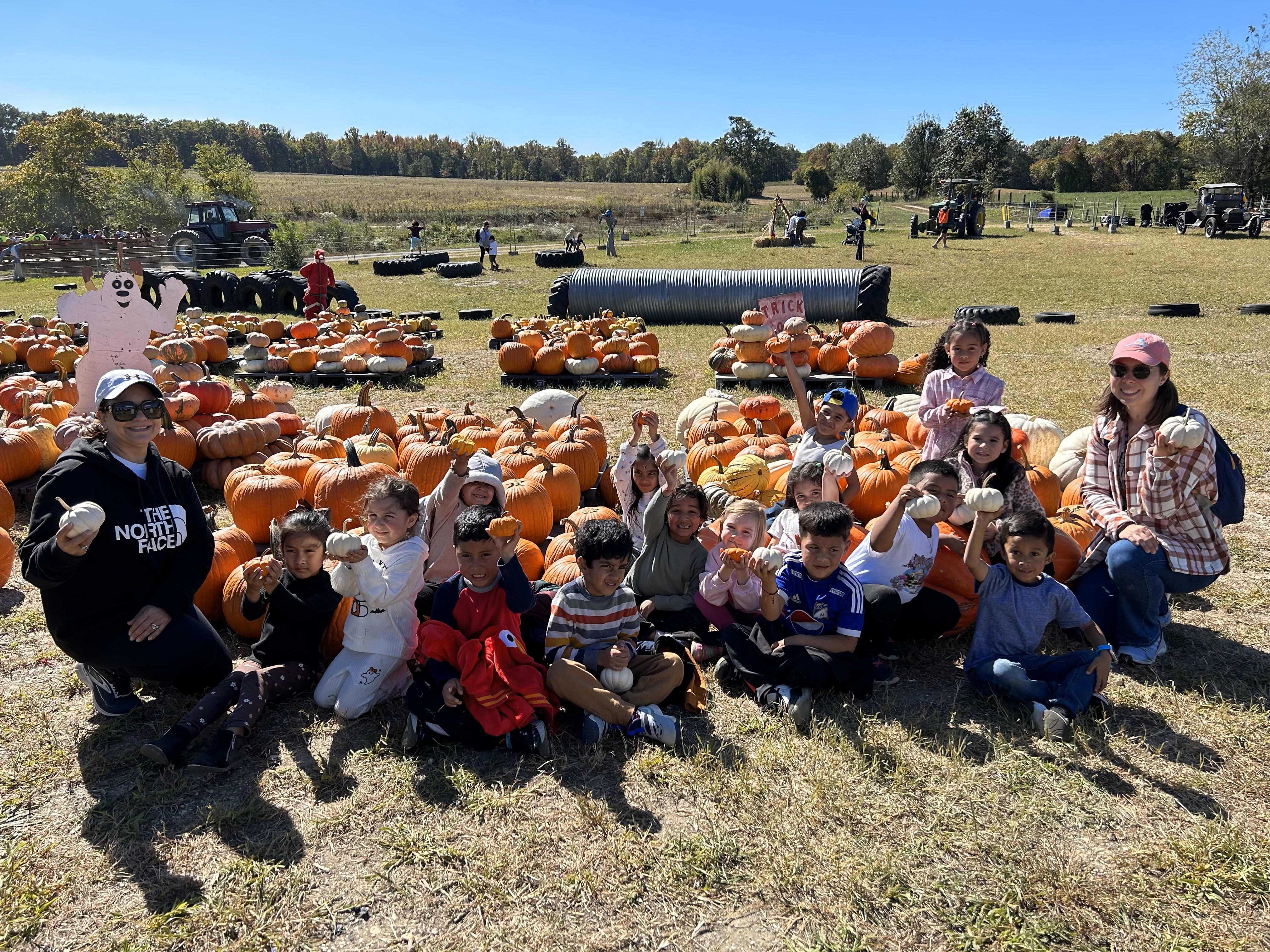 Ms. Hibdon's class poses in front of the pumpkins they picked.