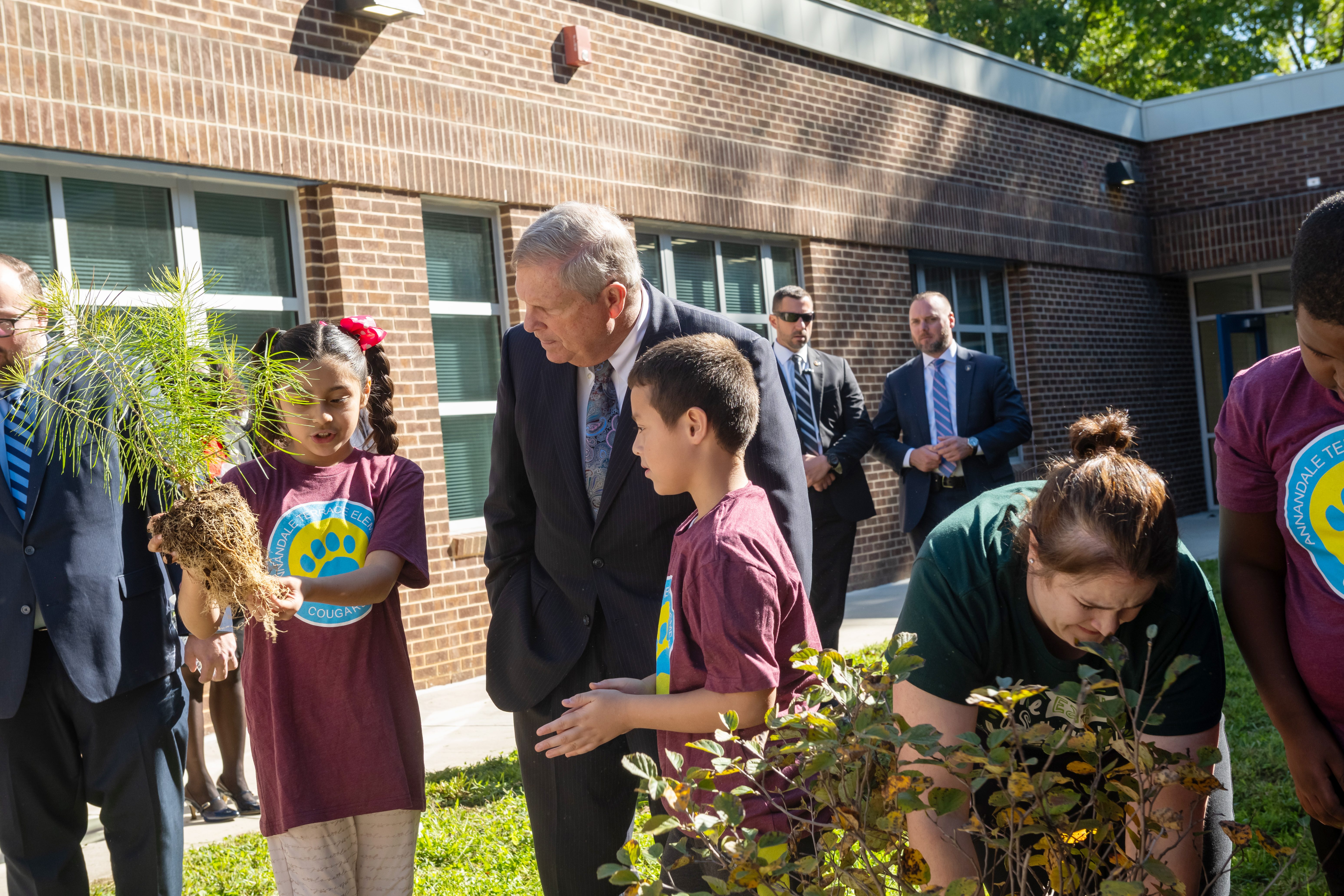 Annandale Terrace Elementary School fifth-graders chat with U.S. Department of Agriculture Secretary Tom Vilsack while they work in their school's learning garden.